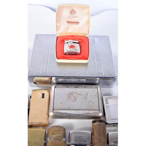 3104 - A collection of lighters and tobacco tins and a vintage rolling machine (33).