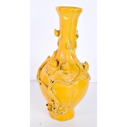 3123 - A Chinese Porcelain yellow ground vase decorated in relief with foliage and flower pods. 31cm.