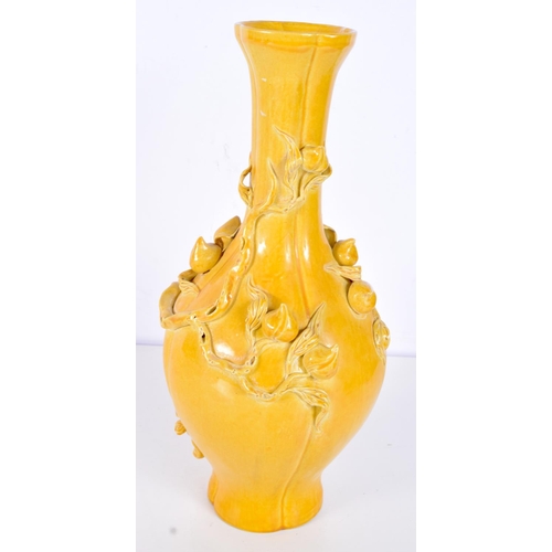 3123 - A Chinese Porcelain yellow ground vase decorated in relief with foliage and flower pods. 31cm.