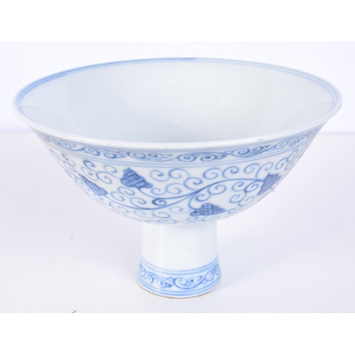 3147 - A Chinese porcelain blue and white stem cup decorated with trailing vines and lotus. 12 x 17cm.