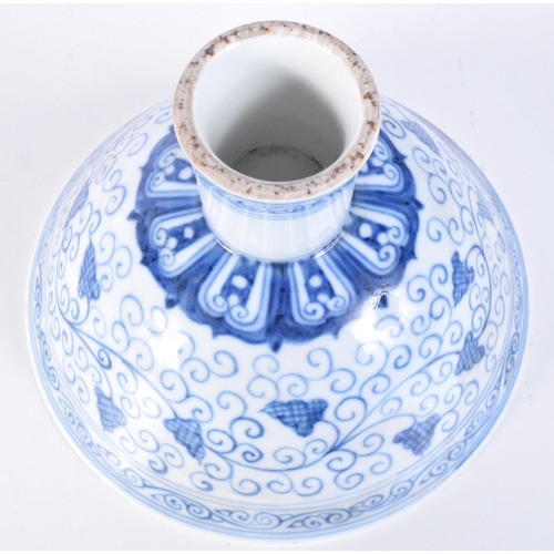 3147 - A Chinese porcelain blue and white stem cup decorated with trailing vines and lotus. 12 x 17cm.