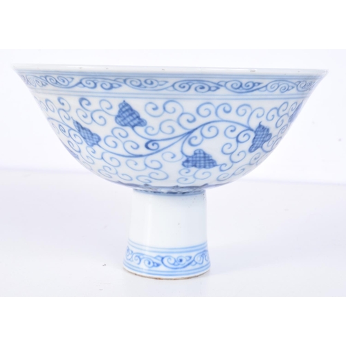 3147 - A Chinese porcelain blue and white stem cup decorated with trailing vines and lotus. 12 x 17cm.