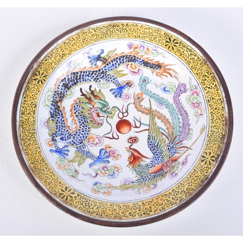 3148 - A Chinese Canton enamelled dish decorated with a dragon and phoenix. 13cm.