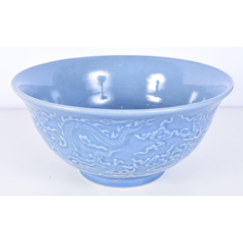 3160 - A Chinese porcelain Celadon bowl decorated in relief with dragons. 11 x 21cm.