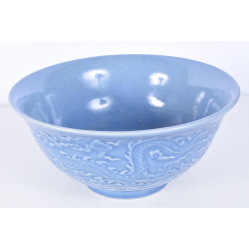 3160 - A Chinese porcelain Celadon bowl decorated in relief with dragons. 11 x 21cm.