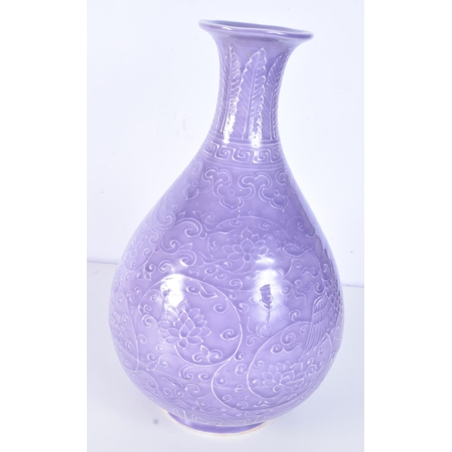 3163 - A Chinese porcelain purple glazed Yuhuchunping vase decorated in relief with lotus plant. 33cm.