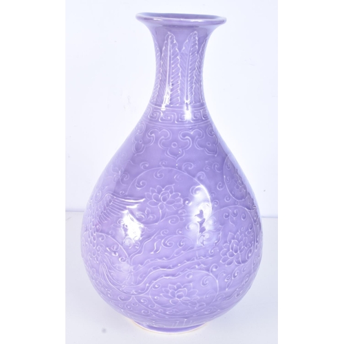 3163 - A Chinese porcelain purple glazed Yuhuchunping vase decorated in relief with lotus plant. 33cm.