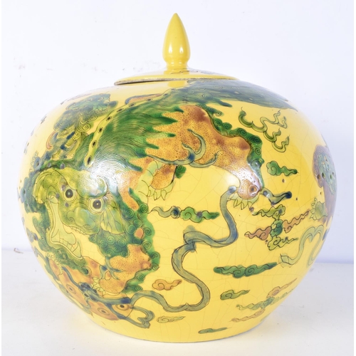 3173 - A Chinese porcelain yellow ground lidded jar decorated with beasts. 23 x 24cm.