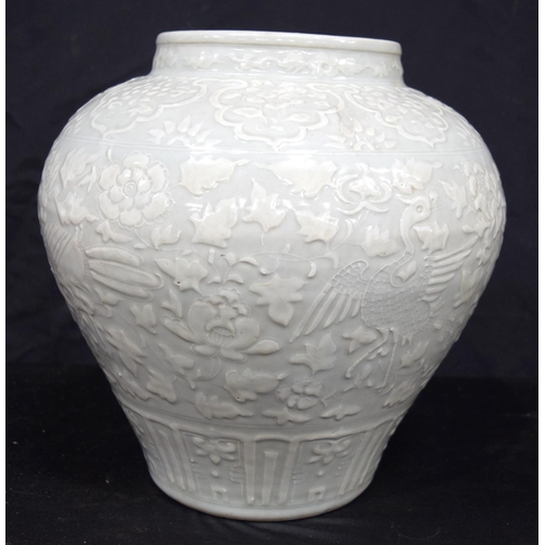 3175 - A large Chinese porcelain celadon jar decorated in relief with cranes and a phoenix. 34 x 34cm.