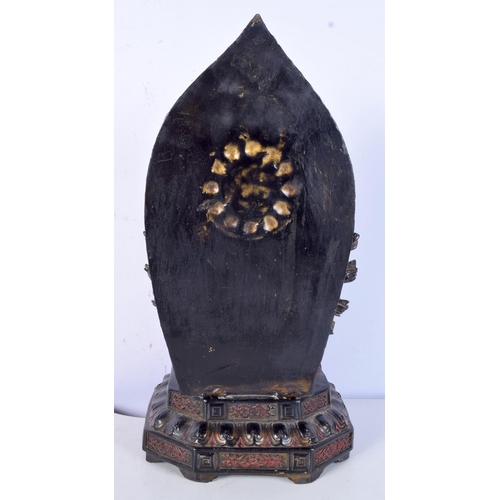 3182 - A Tibetan bronze Buddha sitting on a throne. 35cm high.