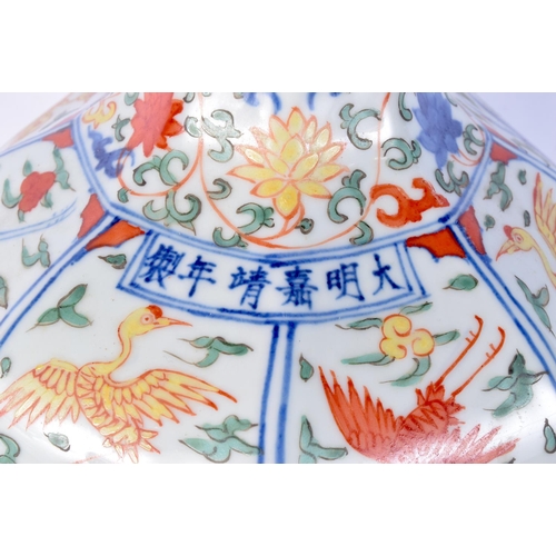 3183 - A Chinese porcelain octagonal sided Wucai vase decorated with cranes in panels. 31cm high.