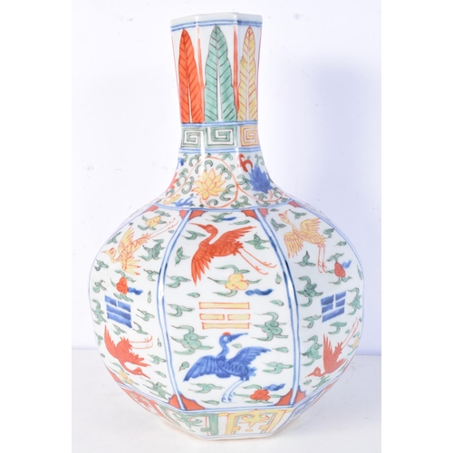 3183 - A Chinese porcelain octagonal sided Wucai vase decorated with cranes in panels. 31cm high.