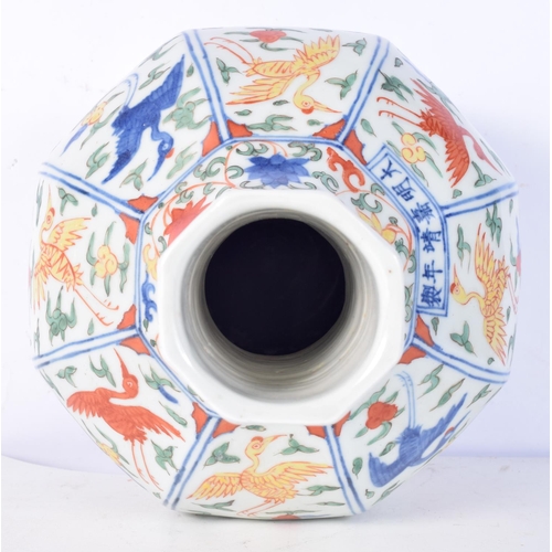 3183 - A Chinese porcelain octagonal sided Wucai vase decorated with cranes in panels. 31cm high.