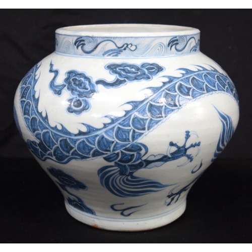 3187 - A Chinese porcelain blue and white vase decorated with a dragon. 20cm high.