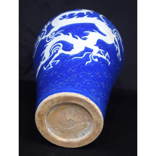 3188 - A large Chinese porcelain sacrificial blue Meiping vase decorated in relief with dragons and clouds.... 