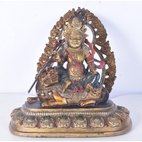 3190 - A Chinese Tibetan gilt bronze Buddha sitting on a beast. 20 cm high.