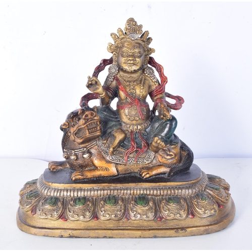 3190 - A Chinese Tibetan gilt bronze Buddha sitting on a beast. 20 cm high.