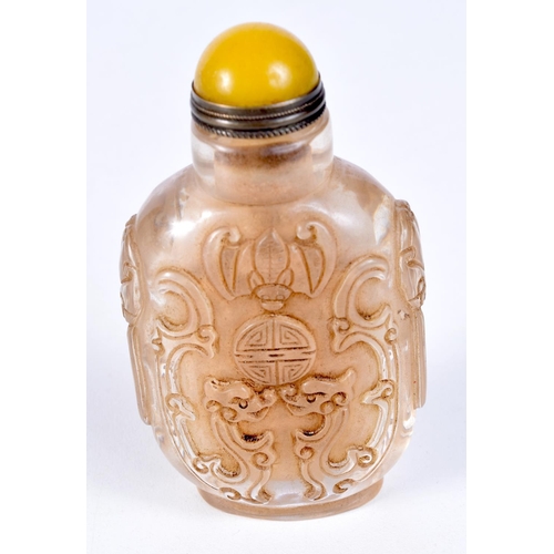 3200 - A Chinese glass snuff bottle decorated in relief with dragons. 9cm.