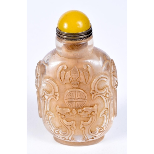 3200 - A Chinese glass snuff bottle decorated in relief with dragons. 9cm.