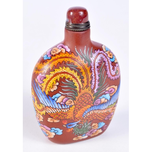 3202 - A Chinese Xining snuff bottle decorated with a dragon and phoenix. 9cm