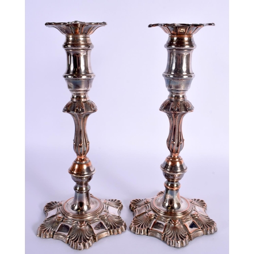 11 - A PAIR OF EARLY 19TH CENTURY OLD SHEFFIELD PLATED CANDLESTICKS formed with acanthus. 25 cm high.