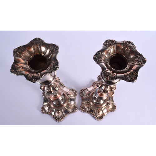 11 - A PAIR OF EARLY 19TH CENTURY OLD SHEFFIELD PLATED CANDLESTICKS formed with acanthus. 25 cm high.