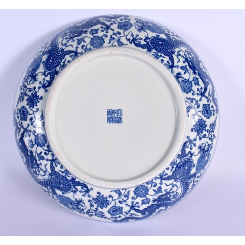 21 - A LARGE CHINESE BLUE AND WHITE PORCELAIN DRAGON DISH 20th Century  bearing Qianlong marks to base. 3... 