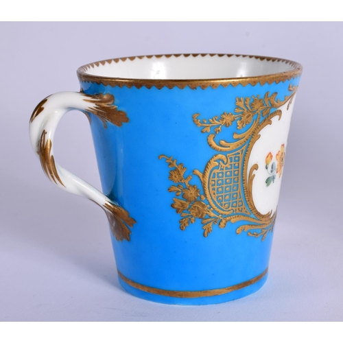 245 - 18TH CENTURY SEVRES TREMBLEUSE CUP AND SAUCER PAINTED WITH FLOWERS IN GILDED CARTOUCHES ON A TURQUOI... 