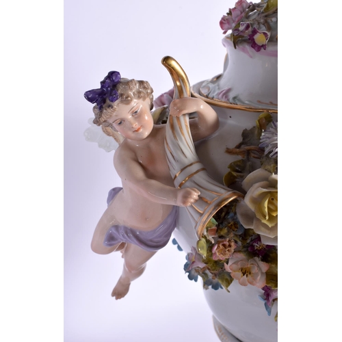 27 - A LARGE EARLY 20TH CENTURY GERMAN PORCELAIN VASE AND COVER with figural cherub supports. 42 cm x 24 ... 