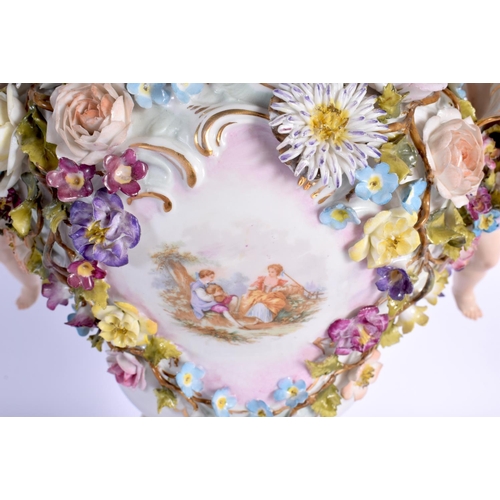 27 - A LARGE EARLY 20TH CENTURY GERMAN PORCELAIN VASE AND COVER with figural cherub supports. 42 cm x 24 ... 