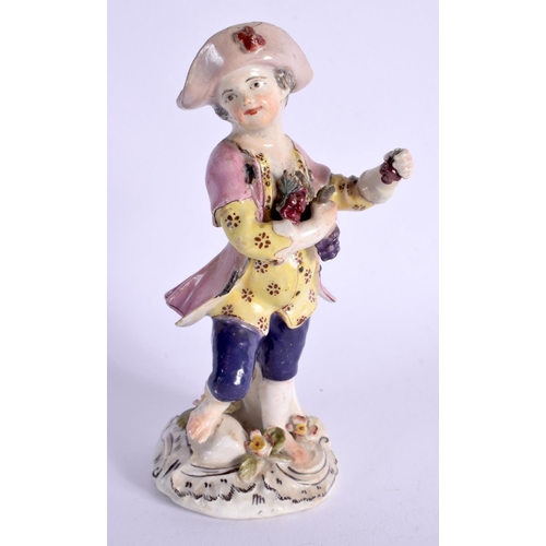 295 - BOW FIGURE OF A BOY GRAPE HARVESTER ON A SCROLL MOULDED MOUND BASE. 13.5cm High