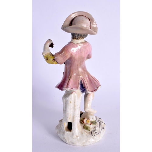 295 - BOW FIGURE OF A BOY GRAPE HARVESTER ON A SCROLL MOULDED MOUND BASE. 13.5cm High