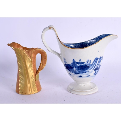 375 - A ROYAL WORCESTER BLUSH IVORY JUG together with a blue and white helmet jug. Largest 10 cm high. (2)
