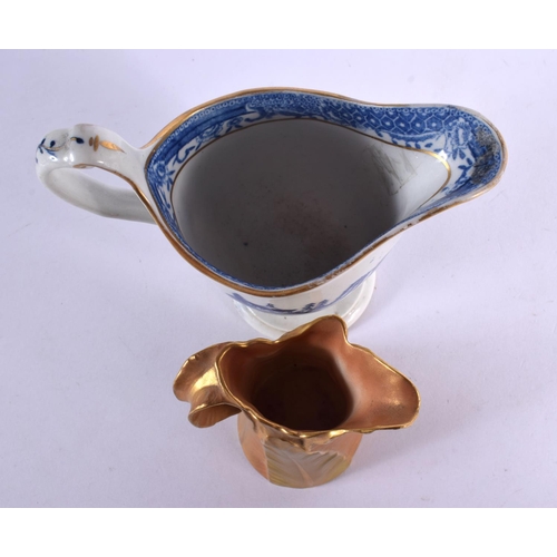 375 - A ROYAL WORCESTER BLUSH IVORY JUG together with a blue and white helmet jug. Largest 10 cm high. (2)
