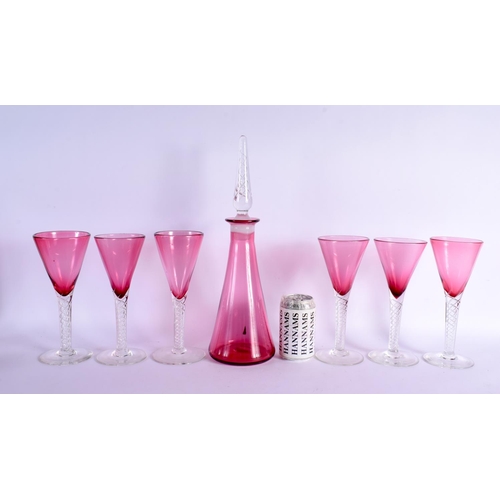 383 - A LARGE VINTAGE CRANBERRY GLASS DECANTER with six glasses. Largest 41 cm high. (7)