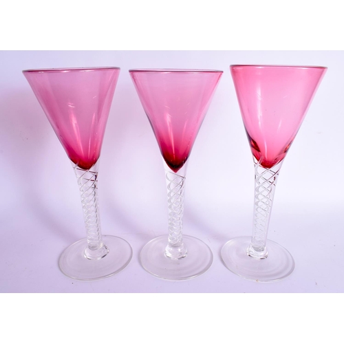 383 - A LARGE VINTAGE CRANBERRY GLASS DECANTER with six glasses. Largest 41 cm high. (7)