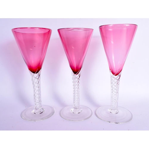 383 - A LARGE VINTAGE CRANBERRY GLASS DECANTER with six glasses. Largest 41 cm high. (7)