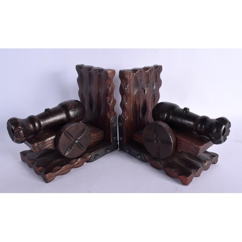 385 - AN UNUSUAL PAIR OF MILITARY CANNON CARVED WOOD BOOK ENDS. 17 cm x 15 cm.