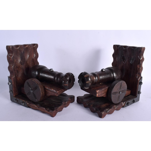 385 - AN UNUSUAL PAIR OF MILITARY CANNON CARVED WOOD BOOK ENDS. 17 cm x 15 cm.