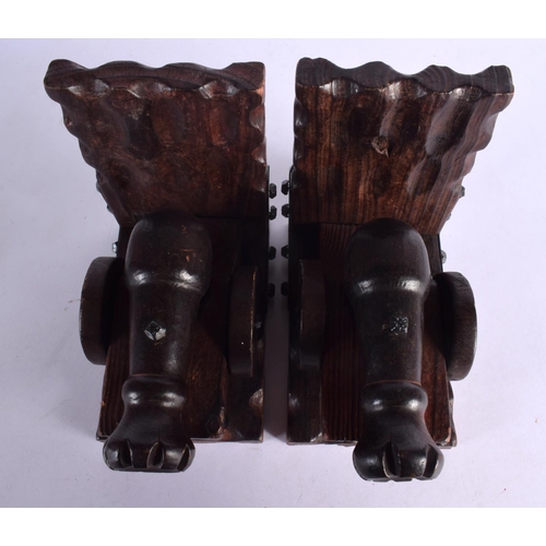 385 - AN UNUSUAL PAIR OF MILITARY CANNON CARVED WOOD BOOK ENDS. 17 cm x 15 cm.