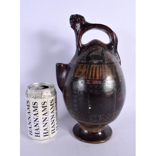 396 - A SOUTH AMERICAN PAINTED PERUVIAN CUSCO POTTERY EWER painted with cats and motifs. 26 cm high.