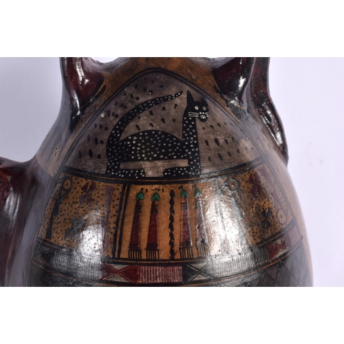 396 - A SOUTH AMERICAN PAINTED PERUVIAN CUSCO POTTERY EWER painted with cats and motifs. 26 cm high.