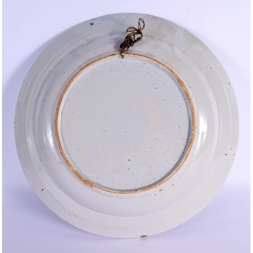 4 - A LARGE 18TH CENTURY DELFT BLUE AND WHITE TIN GLAZED CHARGER painted with flowers. 34 cm diameter.