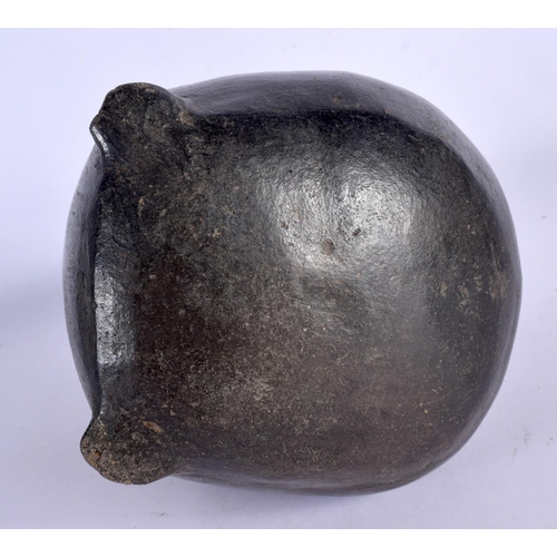 403 - A RARE EARLY SOUTH AMERICAN CARVED AND PAINTED TERRACOTTA VESSEL modelled as a chubby female holding... 