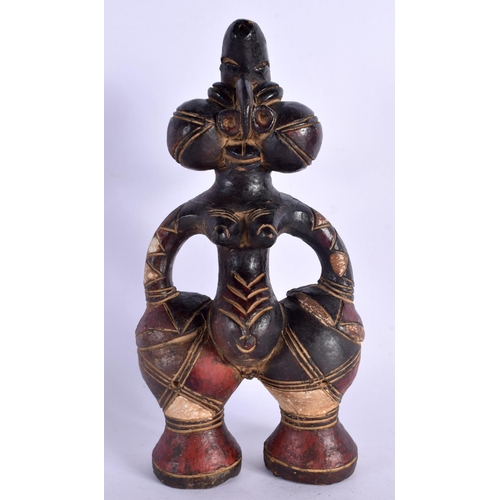 404 - AN UNUSUAL EARLY 20TH CENTURY AFRICAN CARVED AND PAINTED TERRACOTTA FIGURE modelled as a female with... 