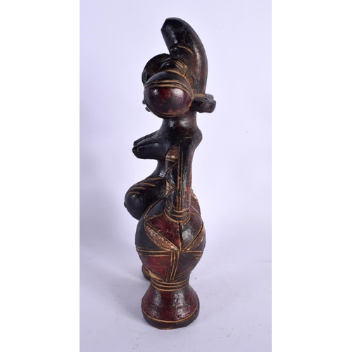 404 - AN UNUSUAL EARLY 20TH CENTURY AFRICAN CARVED AND PAINTED TERRACOTTA FIGURE modelled as a female with... 