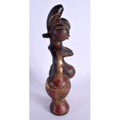 404 - AN UNUSUAL EARLY 20TH CENTURY AFRICAN CARVED AND PAINTED TERRACOTTA FIGURE modelled as a female with... 