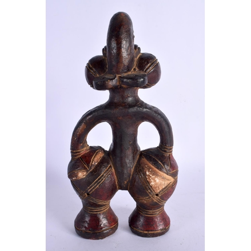 404 - AN UNUSUAL EARLY 20TH CENTURY AFRICAN CARVED AND PAINTED TERRACOTTA FIGURE modelled as a female with... 