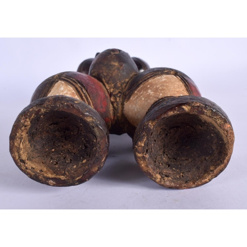 404 - AN UNUSUAL EARLY 20TH CENTURY AFRICAN CARVED AND PAINTED TERRACOTTA FIGURE modelled as a female with... 