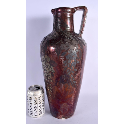 405 - A LARGE ART NOUVEAU FRENCH POTTERY EWER overlaid with trailing berries and vines. 40 cm x 15 cm.